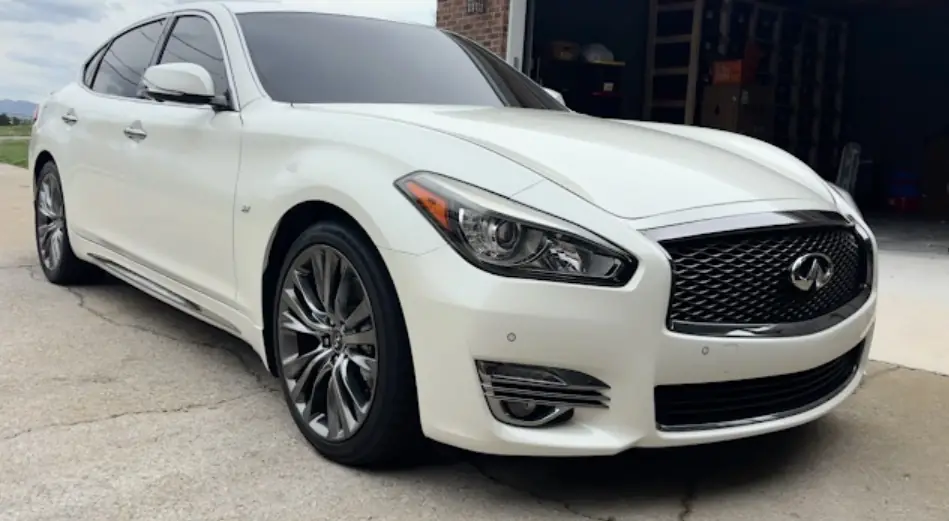 White Infiniti exterior detail with cleaned wheels and body panels