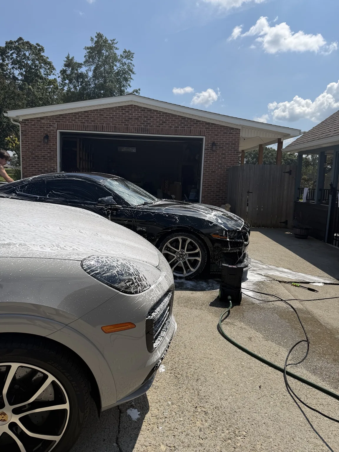Mobile detailing work being performed on vehicles at a customer location