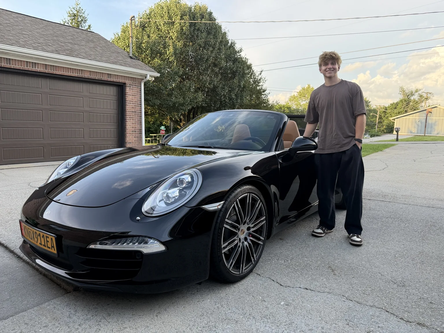 Great Smokey Detailing co-owner beside a detailed Porsche 911